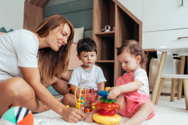 istock Mother playing with toddlers 1443104070