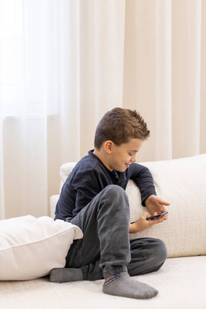 istock Young boy playing with his fathers smart phone 1443105037