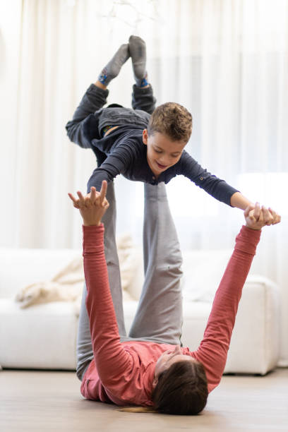 istock Young boy playing aeroplane with his sister 1443106600