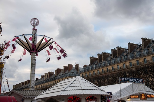Paris, France - November 19, 2022: Saturday afternoon crowd in the Tuileries Christmas Market and funfair