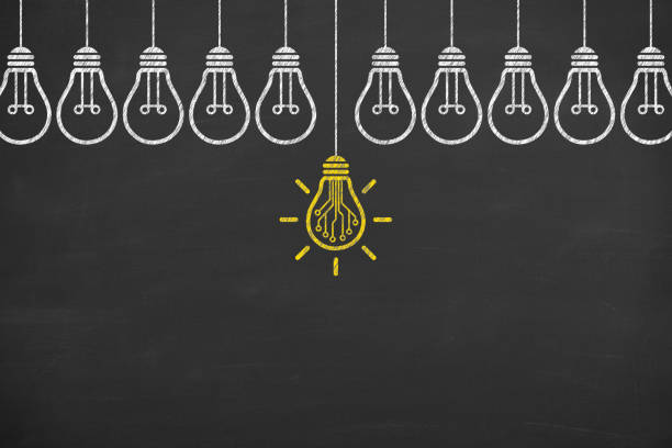 Innovative idea concepts with light bulbs on a chalkboard background stock photo
