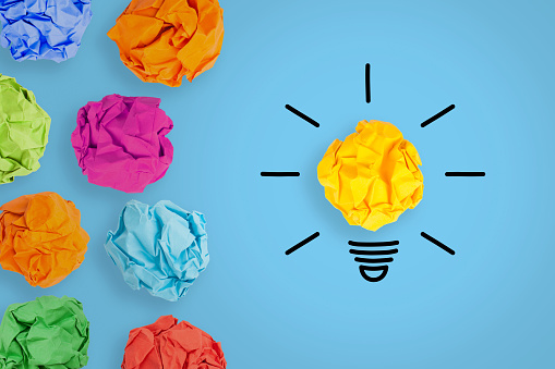 Creative Idea Concepts with Light Bulb Crumpled Paper on Blue Background