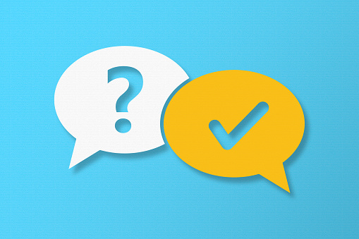 Question and Answer Speech Bubbles with Copy Space On Blue Cardboard Background