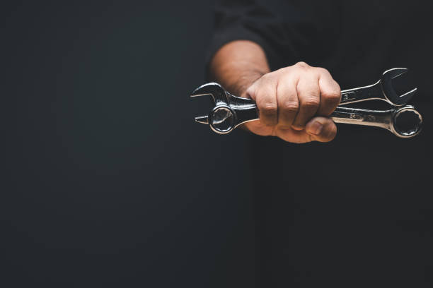 istock Hand holding wrecnh tools of two sizes 1443113084