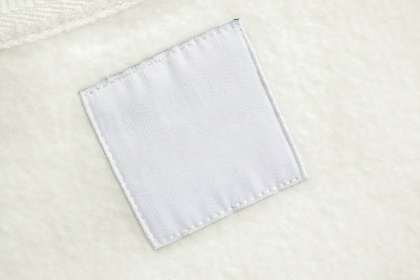istock Blank white laundry care clothes label on fabric texture background 1443114083