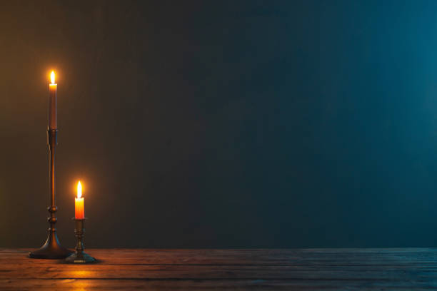istock burning candles in vintage candlesticks on dark background 1443115025