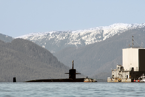 A U.S. Navy Los Angeles-class submarine undergoes testing on Thursday at the Southeast Alaska Acoustic Measurment Facility  in West Behm Canal. Two U.S. Navy patrol boats, each equipped with two M240 machine guns, guarded the vessel and the surrounding restricted area. One support ship was also seen in the area. The facility runs tests to study sounds emitted from a vessel while at idle in the docking bay and within the underway site, which is the area between Betton Island and Helm Bay and extends north to Point Francis. SEAFAC runs tests on both submarine and surface ships. Results are used to further develop and advance stealth technology.