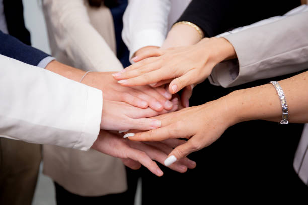 istock Group of business team harmonious with man and woman joining hands stack together in enterprise for victory and success, teamwork of partnership with meeting and cheering for achievement. 1443129311