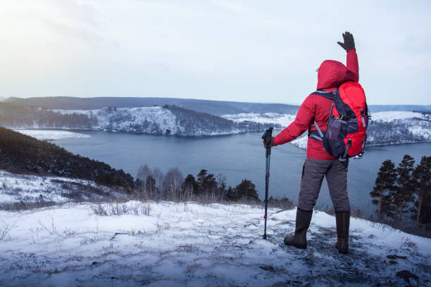 istock Man hiker with backpacks enjoying mountain view during winter vacation. active vacations into the wild. freedom, happy, hiking lifestyle adventure concept. 1443135799