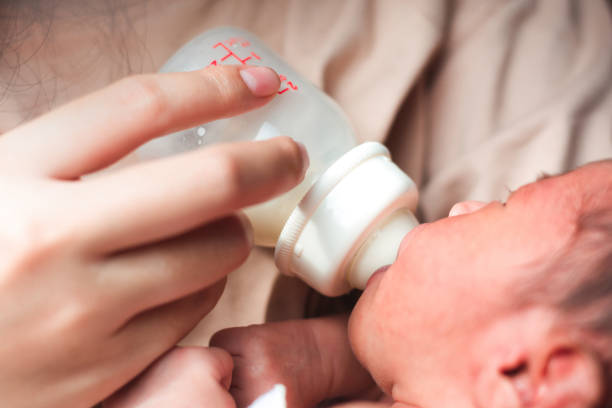 istock Newborn baby drinking milk from a bottle 1443138015