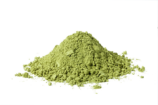 Heap of matcha green tea powder on white background