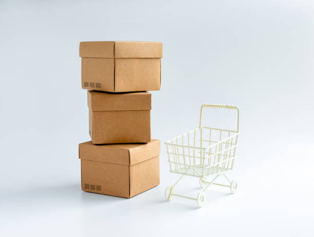 istock Cardboard parcel boxes stack and empty shopping trolley cart isolated on white background. Carton kraft paper box with lid on top. Delivery, cargo, package, online shopping and shipping concepts. 1443141652