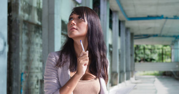 istock Thai woman doing construction site inspection holding pen 1443141918