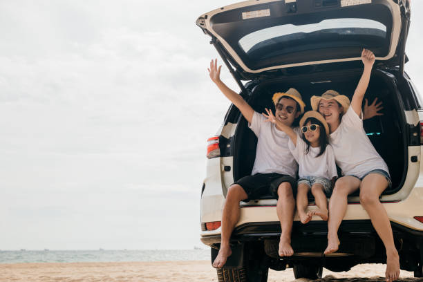 istock people having fun in summer vacation on beach with automobile 1443145351