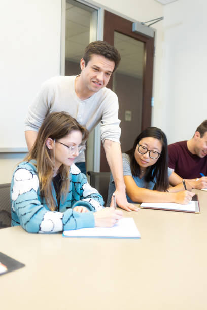 istock Professor Working with Med Students - University Students in Conference Room Learning Medicine - Small Group Teaching - Study Room - Med Student Tutor 1443151088