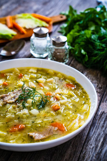 istock Cabbage soup served on wooden table 1443155955