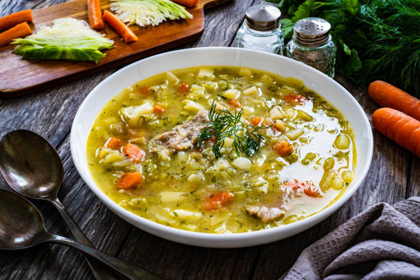 istock Cabbage soup served on wooden table 1443155966