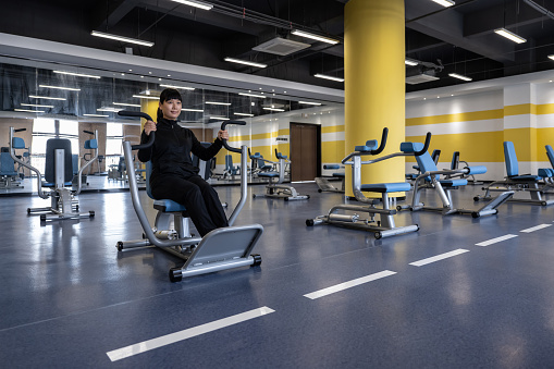 A woman is exercising in the gym