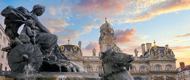 Famous Fontaine des Terreaux at sunset in Lyon, France