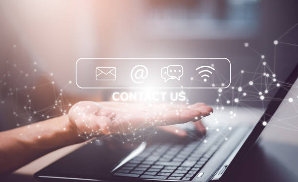 istock Communication and Contact us or Customer support hotline people connect. Hand using a laptop and touching on virtual screen contact icons, email and address, live chat with internet wifi. 1443166882
