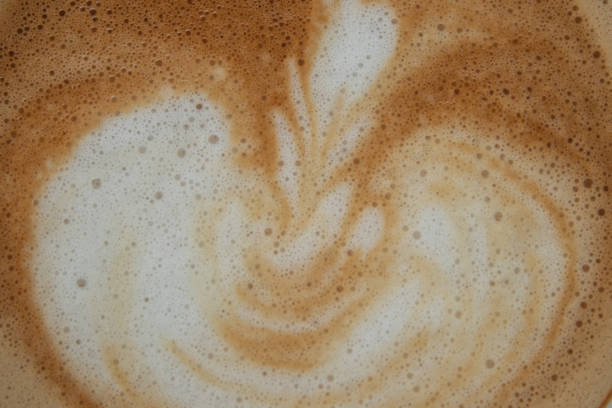 istock closeup hot coffee latte art cup on wood table. 1443168917