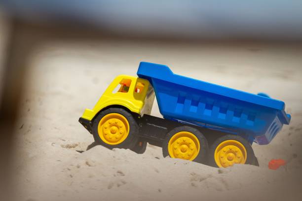 istock Yellow and blue toy rtuck in the sand 1443170182
