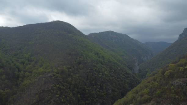 istock Bird's eye view of mountains under a cloudy sky 1443174954