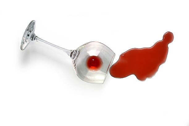 Spilled Wine Spilled red wine on white background. wine glass knocked over stock pictures, royalty-free photos & images