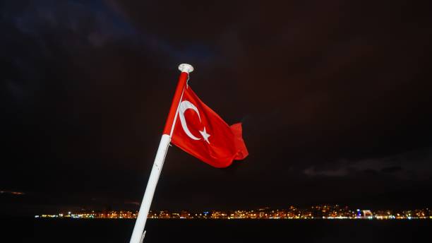 istock Turkish flag brightened during night with city lights on the background 1443175742