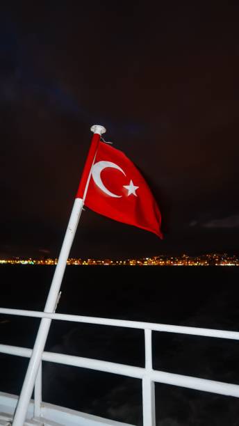 istock Turkish flag brightened during night with city lights in the bac 1443175747