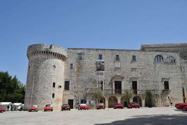 A holiday in Puglia, a region of southern Italy. Conversano, Italy – June 04, 2022: Gathering of sports cars in front of the castle of Conversano, an old town in Lecce province. conversano stock pictures, royalty-free photos & images