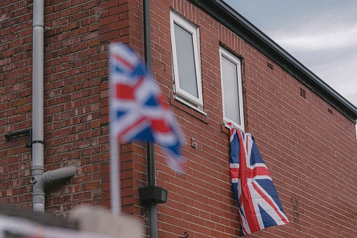 A closeup shot of hanging UK flag from building
