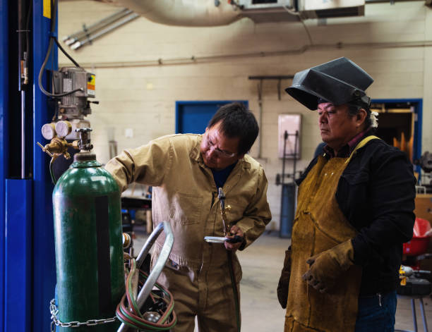 Asian technician welding steel There are sparks from welding steel.