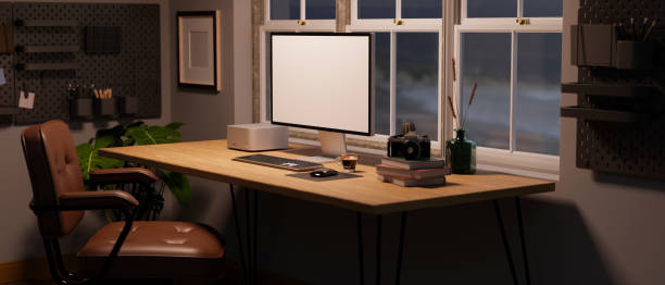 istock Home workspace at night with computer mockup on wood table, vintage brown lather chair 1443178863