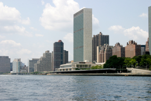 United Nations Secretariat building and East River skyline viewed from the New York East River.