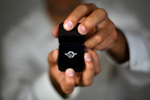 Marry me A man proposing and holding up an engagement ring jewelry box photos stock pictures, royalty-free photos & images