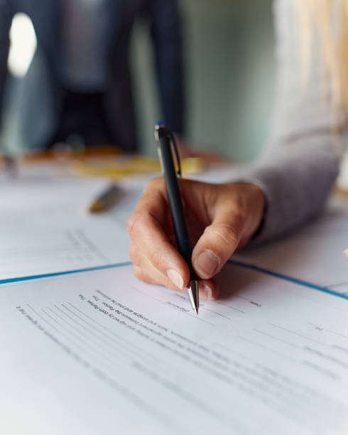 Signing a contract! Close up of unrecognizable woman signing a contract. filling out stock pictures, royalty-free photos & images