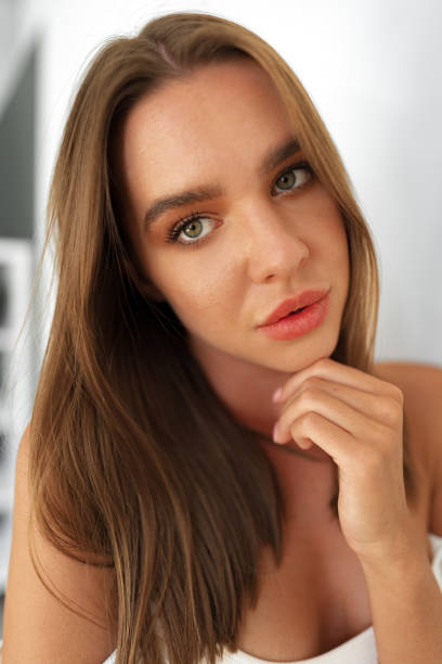 istock Beautiful attractive young woman with makeup posing in the studio on white 1443181685