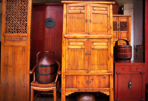 Wooden old fashioned huge wardrobe in rustic home interior. Three-door wardrobe, triple door.