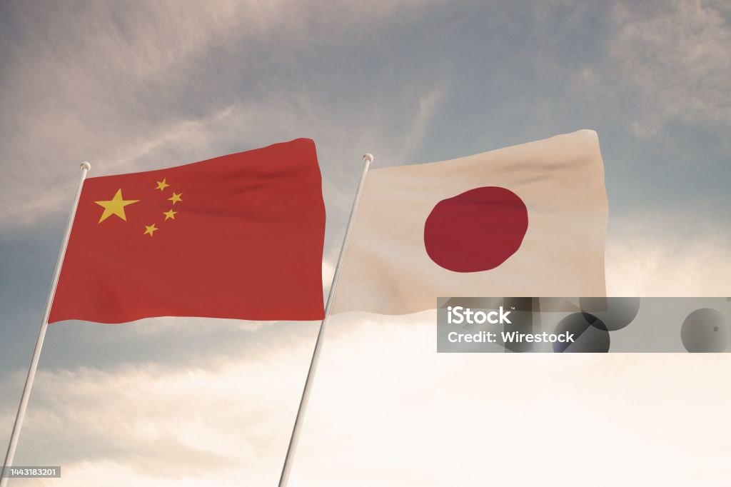 Flags of China and Japan waving with cloudy blue sky background, 3D rendering United States of Ameri Flags of China and Japan waving with cloudy blue sky background, 3D rendering United States of America, Chinese Communist Party CCP. Agreement Stock Photo