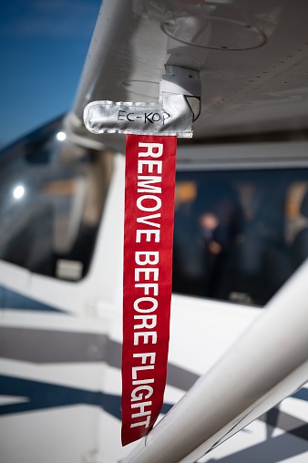 Remove Before Flight reminder tag hanging from the wing