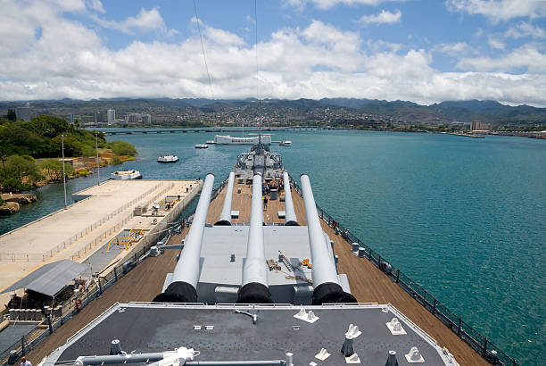 Looking out at the water from the bow of the U.S.S. Missouri View from the top deck of the  U.S.S. Missouri in Pearl Harbor, Hawaii. The Arizona Memorial is also visible. battleship photos stock pictures, royalty-free photos & images