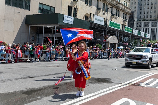 – June 13, 2022: The large crowds of people in the streets of Manhattan celebrating the Puerto Rican Day Parade