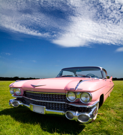 A classic 1959 pink Cadillac Coupe de Ville dream machine in dynamic full frontal. 