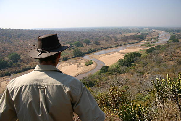 Ranger checking out amazing view Guy checking out amazing view in Africa park ranger stock pictures, royalty-free photos & images