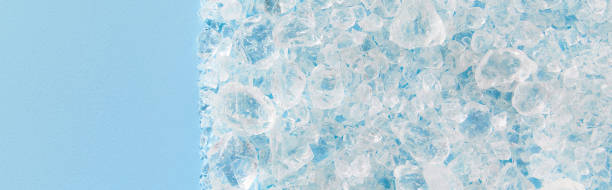 istock Close up crushed ice in sunlight on blue with copy space. Summer background refreshment concept 1443187790