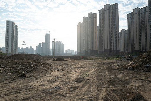 An empty construction site in front of an urban community in Putian, Fujian Province
