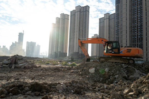 istock Excavator on a construction empty dirt site in the morning 1443187867
