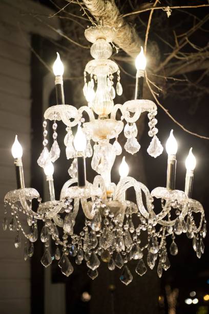 istock Vertical shot of an illuminated chandelier hanging from a tree 1443189241