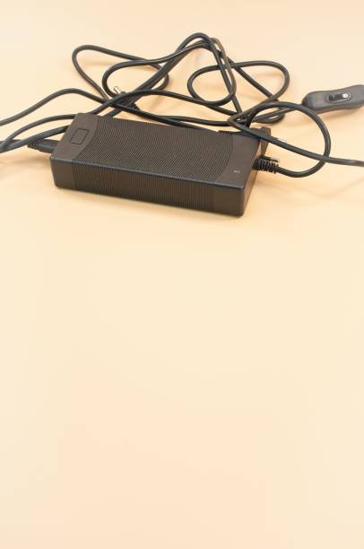 istock power supply with cables isolated on a beige desk background 1443190860